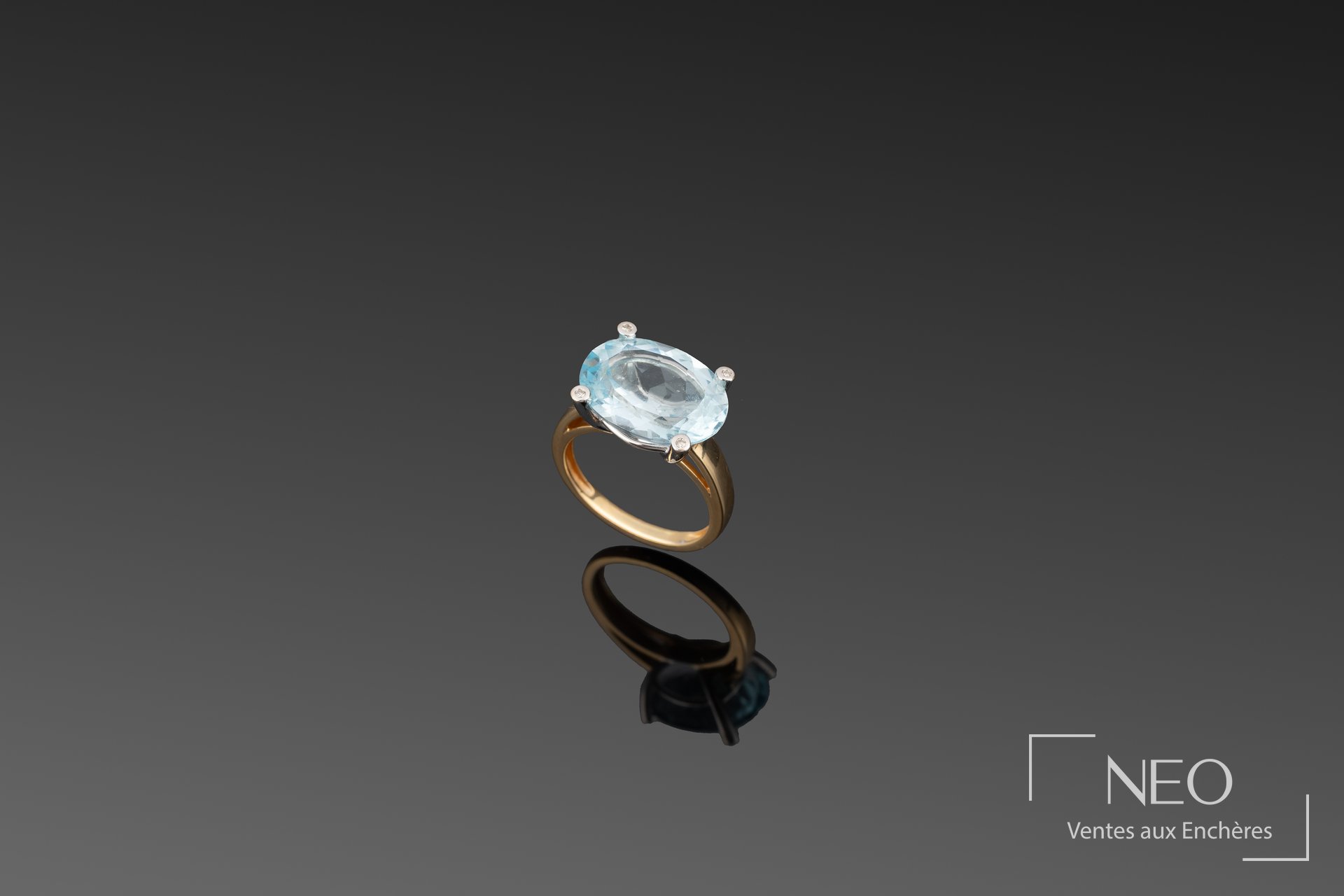Bague en or jaune 18K sertie d’une topaze bleue ovale