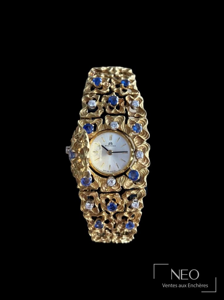 Montre bracelet Bucherer en or jaune sertie de saphirs et diamants