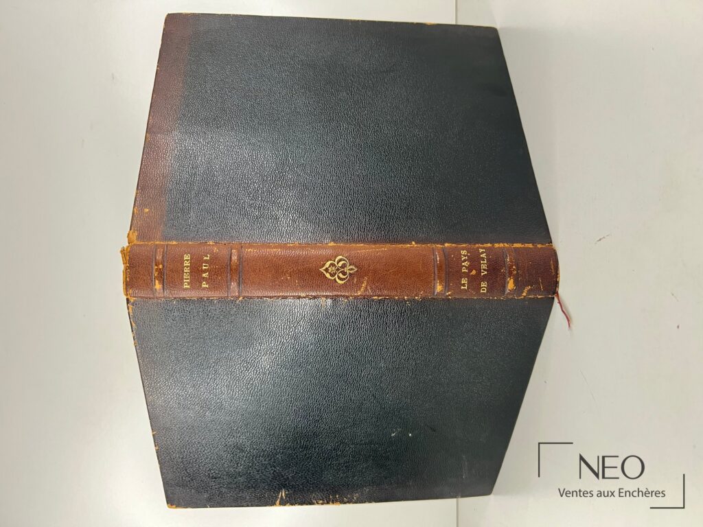 Livre relié en chagrin noir avec dos brun titré en doré