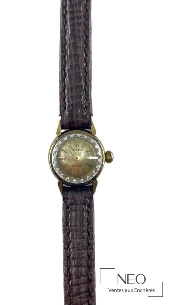 Montre Rolex Orchid en or jaune avec cadran champagne signé et bracelet cuir marron